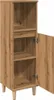 A tall, narrow wooden cabinet with one door open, revealing shelves inside. It stands on four short legs. Náhled obrázku produktu