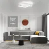 A modern living room with a sectional sofa, coffee table, and a ceiling light. Produktbild-Vorschau