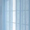 A close-up view of light blue sheer curtains hanging in front of a window. Produktbild-Vorschau