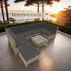 A rattan lounge set with gray cushions is placed on a tiled patio overlooking the ocean at sunset. Náhled obrázku produktu