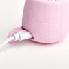 A close-up shot of a pink Bluetooth speaker being charged by a white USB cable. Náhľad obrázku produktu