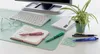 A desk scene with office supplies including a keyboard, glasses, a notebook, pens, envelopes, and a plant. Voir les images du produit