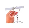 A hand is shown attaching a metal hanger with multiple clips to a white rod. Produktbild-Vorschau