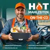 A man in a truck holding a lunchbox filled with food. Produktbild-Vorschau