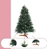 A green artificial Christmas tree with a wooden stand, shown with close-up details of its branches and stand. Produktbild-Vorschau
