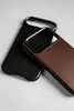 Two phone cases, one black and one brown, are placed diagonally on a light gray surface. Anteprima dell’immagine prodotto