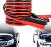 A coiled set of red and black jumper cables is shown above two cars, one black and one white, with their hoods open and jumper cables connected. Podgląd zdjęcia produktu