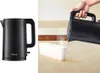 A split image showing a black electric kettle on the left and a hand pouring hot water from the kettle into a line of white mugs on the right. Anteprima dell’immagine prodotto