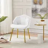 A white accent chair with gold legs in a well-lit room. Produktbild-Vorschau