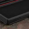 A close-up view of a black phone case with a red accent and the brand name 'TORRO' embossed on it, resting on a textured surface. Anteprima dell’immagine prodotto