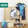 A messy pile of clothes on top of a dresser, with a laundry basket and shoes on the floor. Voir les images du produit