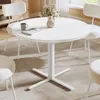 A round white dining table with chairs in a bright, modern room. Produktbild-Vorschau