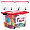 Three transparent storage boxes with red lids and wheels, filled with colorful toys. Produktbild-Vorschau