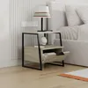 A bedside table next to a bed, with a lamp and books on it. Produktbild-Vorschau
