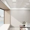 A modern office interior with a large window, a built-in bench, and a desk with a laptop and a plant. Náhled obrázku produktu