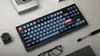 A keyboard and other office supplies are arranged on a light gray surface. Náhľad obrázku produktu