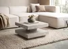 A modern living room scene featuring a sectional sofa, a coffee table, and a rug. Produktbild-Vorschau