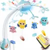 A baby mobile with hanging owl and bear toys, attached to a crib, with a remote control in hand. Náhľad obrázku produktu