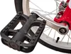 A close-up view of a bicycle pedal and part of the wheel and frame. Náhled obrázku produktu