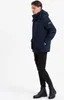 A man wearing a navy blue winter jacket and black pants, standing against a white background. Produktbild-Vorschau