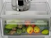 A close-up view of the interior of a refrigerator, showing a drawer filled with fresh produce and a pot on the shelf above. Produktbild-Vorschau