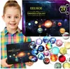 A young girl is holding a product box and a collection of planet-themed ornaments is displayed in front of it. Náhled obrázku produktu