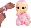 A doll and a hand wearing a watch. Anteprima dell’immagine prodotto