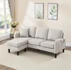A beige L-shaped sectional sofa with a chaise lounge is shown in a well-lit room with a window and curtains in the background. Anteprima dell’immagine prodotto