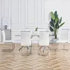 A dining room set with a glass-top table and white chairs. Produktbild-Vorschau