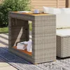 An outdoor patio scene with a wicker side table and sofa. Náhled obrázku produktu