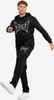 A man wearing a black Tapout tracksuit, posing against a white background. Produktbild-Vorschau