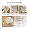 Collage of images showing a round makeup mirror with LED lights, demonstrating different light colors and adjustable brightness. Náhľad obrázku produktu