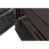 A close-up view of a metal spring mechanism on a dark-colored stove. Produktbild-Vorschau