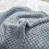 A close-up view of a soft, textured gray blanket. Podgląd zdjęcia produktu