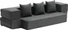 A dark gray convertible sofa with three throw pillows. Voir les images du produit