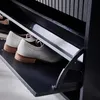 A close-up view of white oxford shoes on a black shoe cabinet. Produktbild-Vorschau