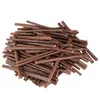 A pile of brown, stick-shaped dog treats. Produktbild-Vorschau