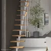 A modern interior with a spiral staircase, a plant, and a television. Produktbild-Vorschau