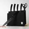 A set of black kitchen knives and scissors in a black knife block, displayed on a white surface with a light gray textured background. Podgląd zdjęcia produktu