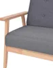 A close-up view of the armrest and seat of a dark gray fabric armchair with a light wood frame. Náhled obrázku produktu