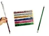 A hand holding a glitter wand, with a collection of glitter wands in the background and another glitter wand on the right. Produktbild-Vorschau