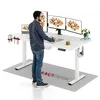 A man is standing at a white standing desk with multiple monitors, a laptop, and office accessories. Podgląd zdjęcia produktu