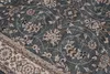 A close-up view of a patterned rug, showing intricate floral designs and a decorative border. Voir les images du produit