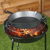 A cast iron skillet is placed on a grill over hot coals. Náhled obrázku produktu