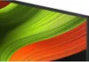 A close-up view of a television screen displaying a colorful abstract wallpaper. Produktbild-Vorschau