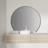 A modern bathroom vanity with a round mirror above a sink and wooden drawers. Anteprima dell’immagine prodotto