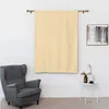 A room setting with a chair, curtains, and a small table with decorative items. Voir les images du produit
