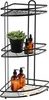 A black metal corner shower caddy with three shelves, holding soap dispensers, a potted plant, and a loofah. Podgląd zdjęcia produktu