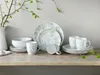 A set of dishes with a floral pattern is displayed on a wooden shelf. Náhľad obrázku produktu