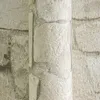 A close-up view of textured wallpaper designed to resemble a stone wall. Náhľad obrázku produktu